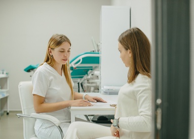 A female doctor discusses health and egg donation requirements with a patient during a consultation at Reprofit.